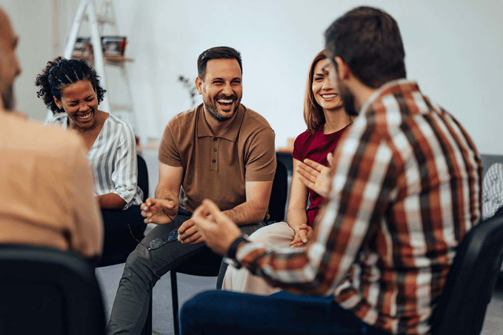 a group of people sit in a circle and talk about what are outpatient treatment programs