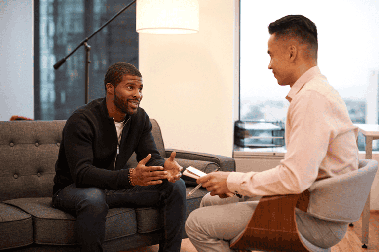 two men talk about the purpose of men's rehab