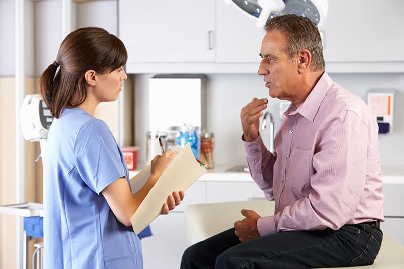 Clinician completing an initial assessment of a patient in the intensive outpatient program at Virtue Recovery Center